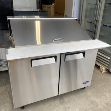 Angled view of sandwich preparation table double door cooler lid closed