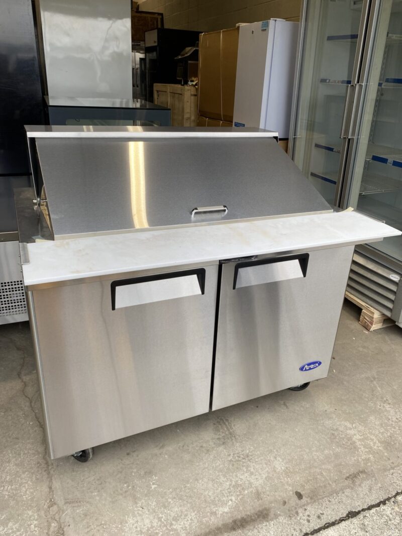 Angled view of sandwich preparation table double door cooler lid closed