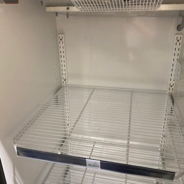 Front view inside freezer with white wire shelves