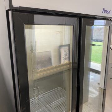 Angled left side of Atosa upright white and black freezer glass double doors