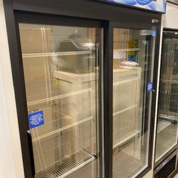 Angled front left side view Fogel white and blue upright 2 glass door display cooler with white shelves inside
