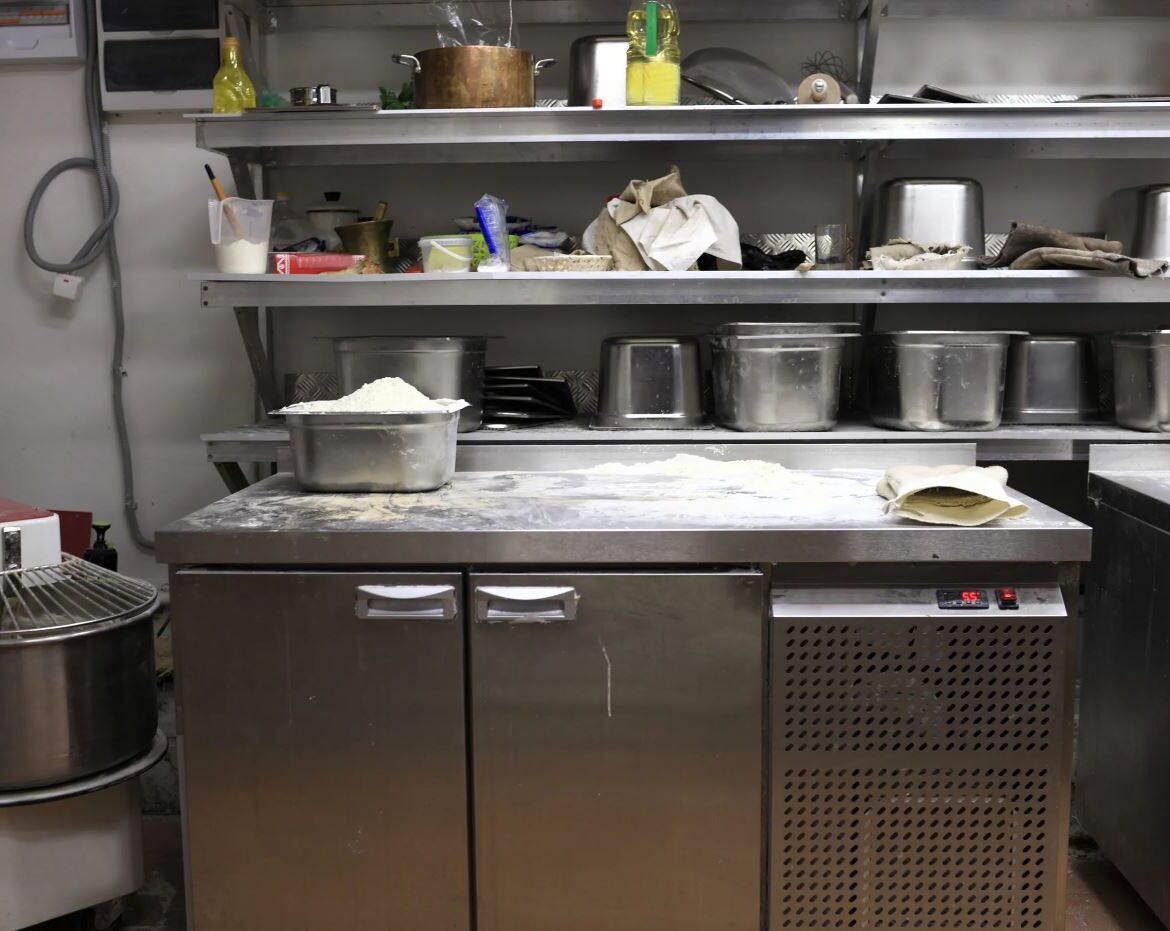 Commercial Kitchen Under counter Freezer with flour and pans on top