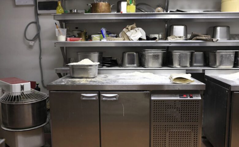 Commercial Kitchen Under counter Freezer with flour and pans on top