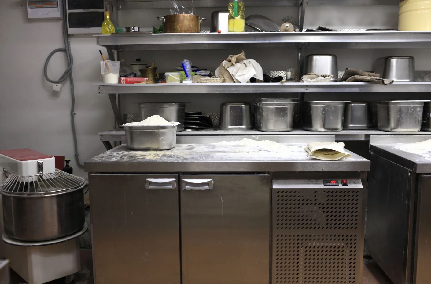 Commercial Kitchen Under counter Freezer with flour and pans on top