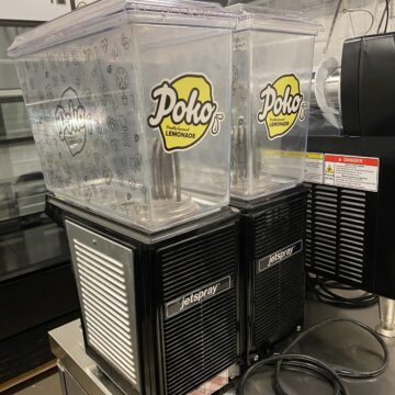 Back view of dual beverage dispenser , plug in back and poko sticker