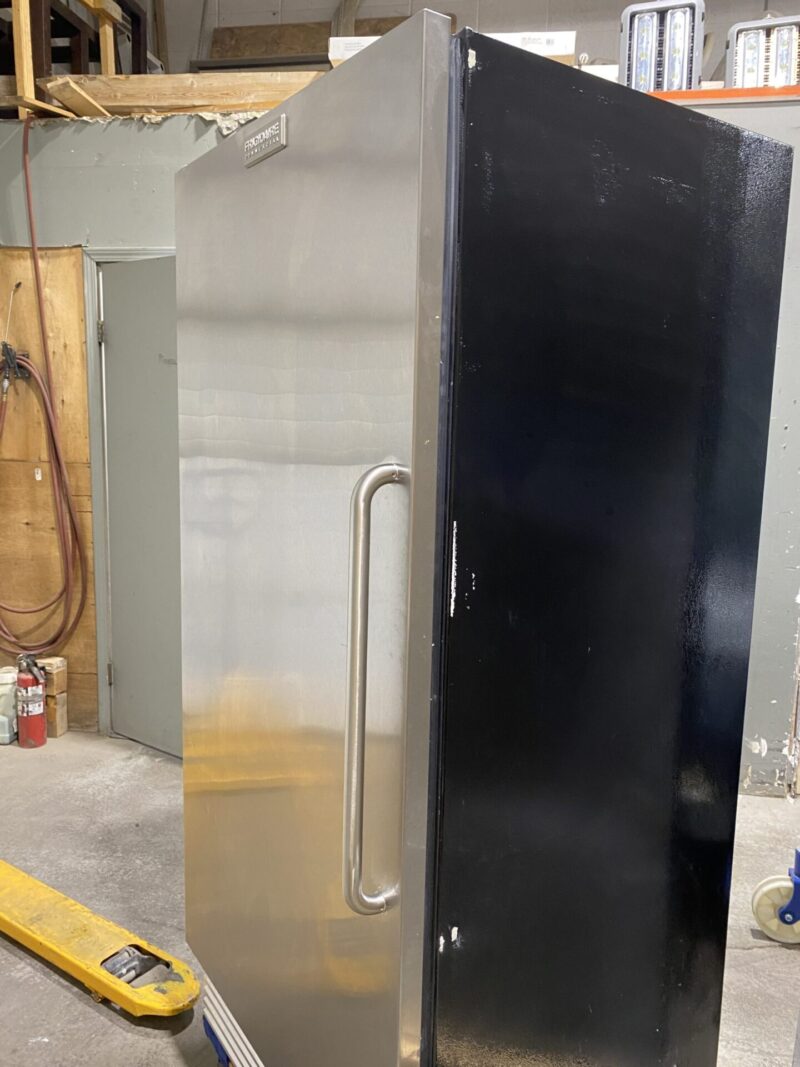 Front side view of stainless steel front door and black sides upright commercial freezer