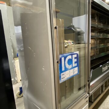 Front side view of upright commercial glass door ice freezer