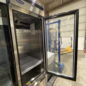 Front side view of open glass door , upright commercial freezer