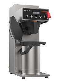 Angled view of the left side of a commercial coffee maker with a single thermos with the lid off